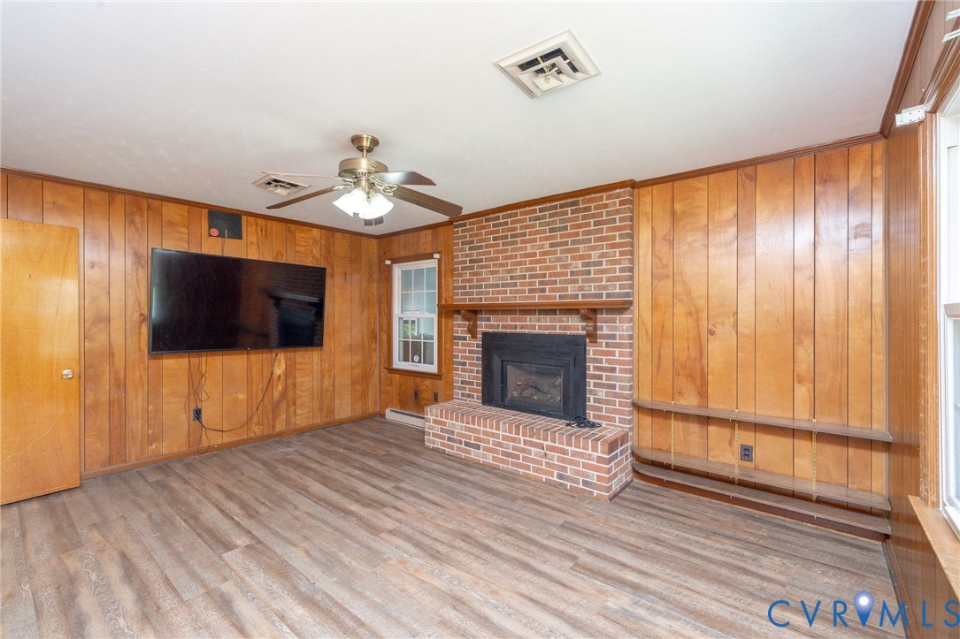 1210 Wellington Road Colonial Heights, VA 23834 - Photo 21 of 46 a view of a livingroom with a fireplace a ceiling fan and wooden floor