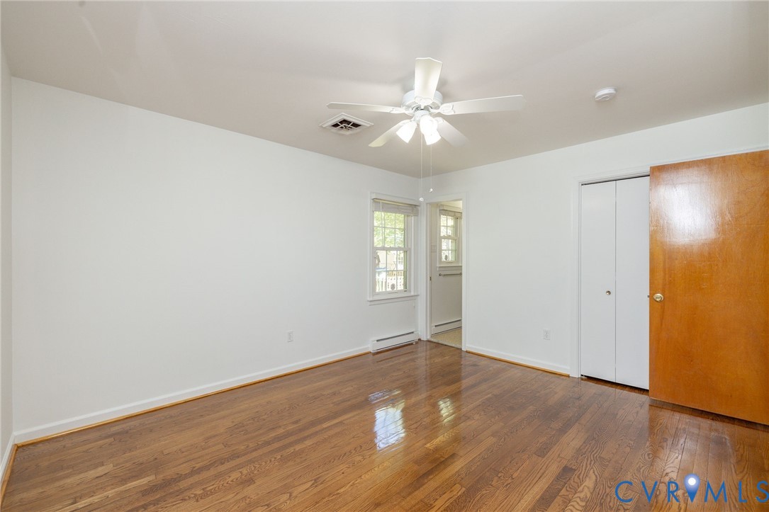 1210 Wellington Road Colonial Heights, VA 23834 - Photo 23 of 46 an empty room with wooden floor and windows