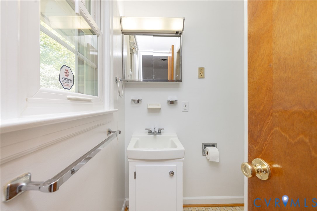 1210 Wellington Road Colonial Heights, VA 23834 - Photo 26 of 46 a bathroom with a sink a mirror and vanity