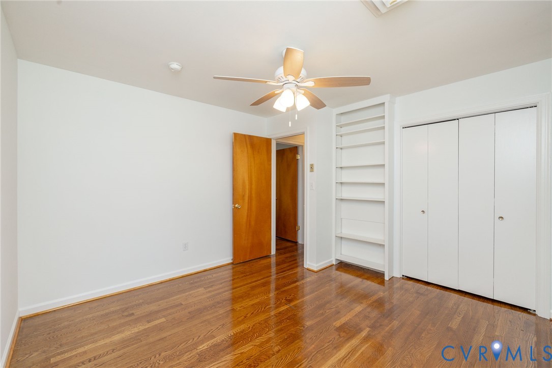 1210 Wellington Road Colonial Heights, VA 23834 - Photo 28 of 46 an empty room with wooden floor closet fan and windows