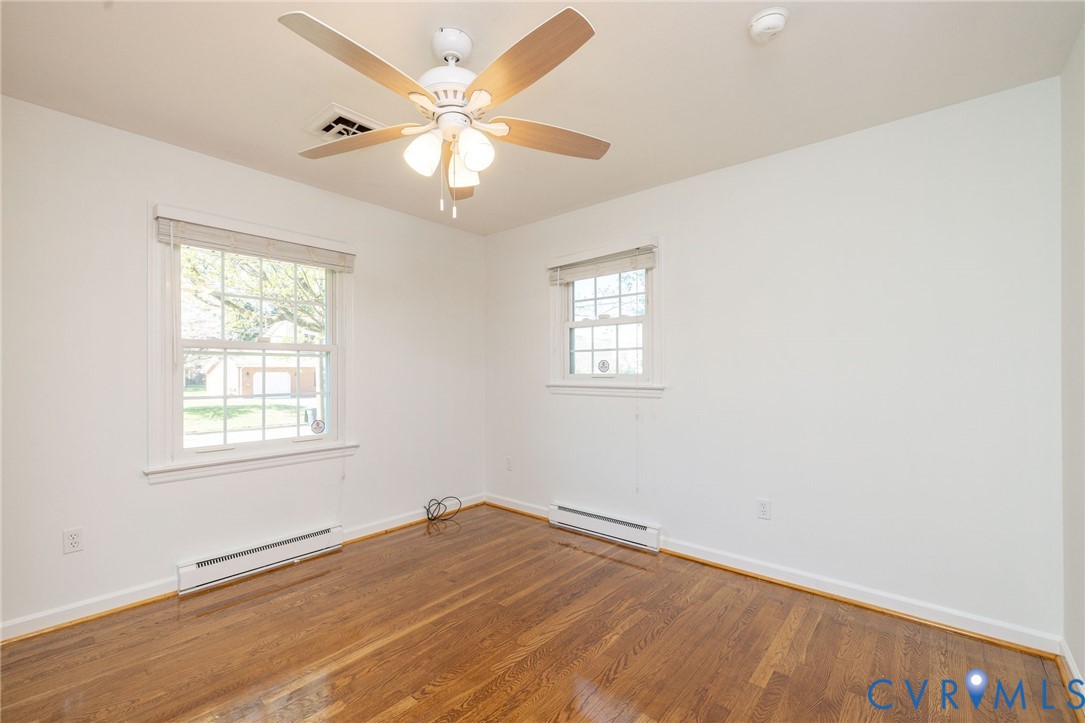 1210 Wellington Road Colonial Heights, VA 23834 - Photo 31 of 46 an empty room with wooden floor and windows