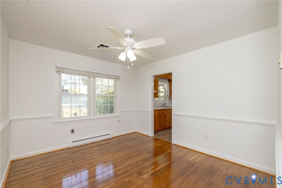 1210 Wellington Road Colonial Heights, VA 23834 - Photo 35 of 46 an empty room with wooden floor fan and windows