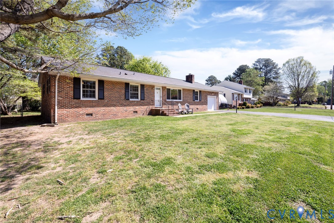 1210 Wellington Road Colonial Heights, VA 23834 - Photo 43 of 46 a front view of a house with a garden and trees