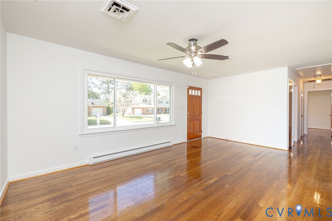1210 Wellington Road Colonial Heights, VA 23834 - Photo 7 of 46 a view of an empty room with wooden floor and a window