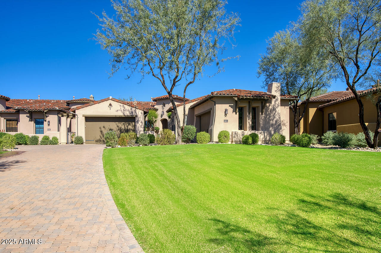 9190 East Hoverland Road Scottsdale, AZ 85255 - Photo 1 of 35 a front view of a house with garden