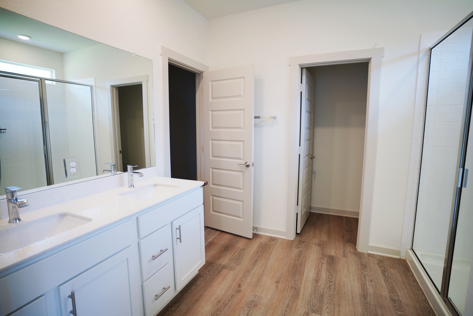 10601 Gonzales Ranger Pass Austin, TX 78754 - Photo 6 of 17 a spacious bathroom with a double vanity sink and mirror