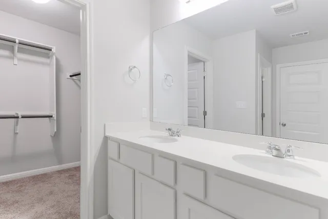 a bathroom with a granite countertop toilet and a sink