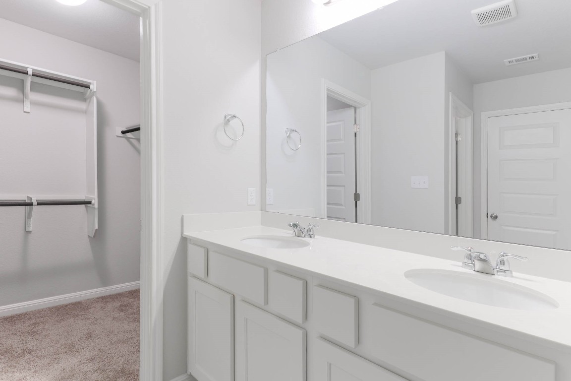 2020 Arendale Drive Leander, TX 78641 - Photo 16 of 22 a bathroom with a double vanity sink mirror and double