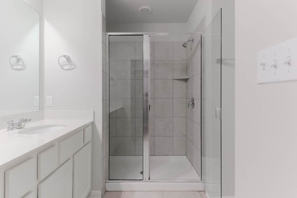 2020 Arendale Drive Leander, TX 78641 - Photo 18 of 22 a bathroom with a shower and a sink