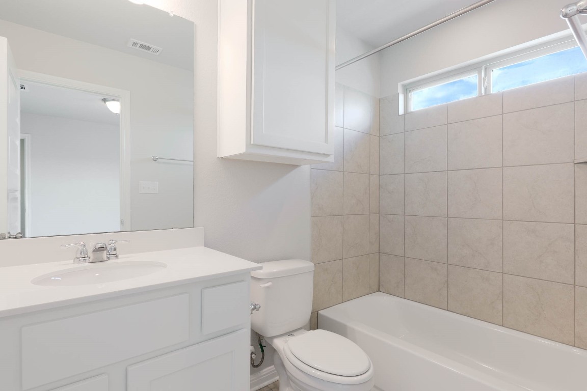 2020 Arendale Drive Leander, TX 78641 - Photo 20 of 22 a bathroom with a sink a toilet and shower