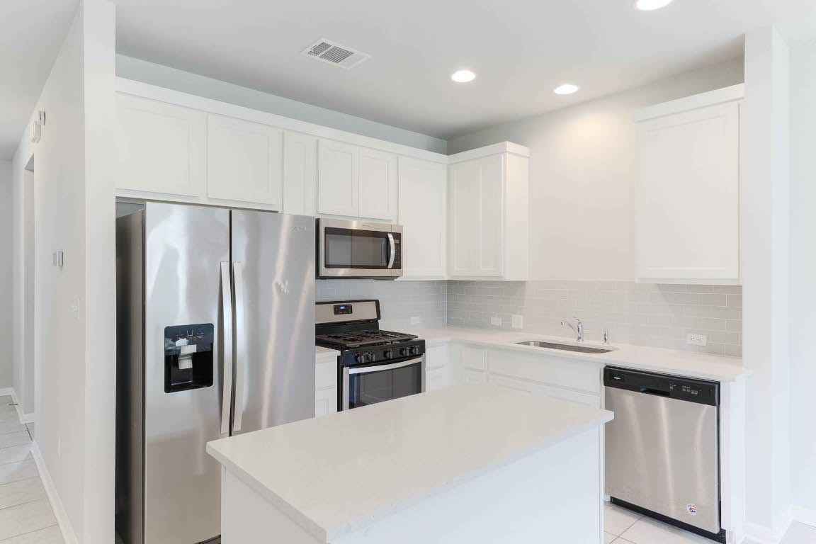 2020 Arendale Drive Leander, TX 78641 - Photo 10 of 22 a kitchen with stainless steel appliances a refrigerator stove microwave and sink