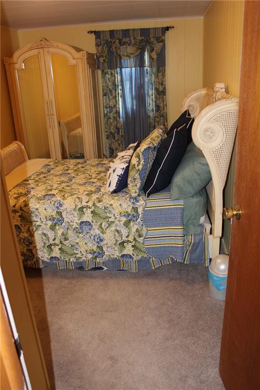 1092 Old State Road New Castle, PA 16101 - Photo 10 of 12 a bedroom with a bed and a mirror