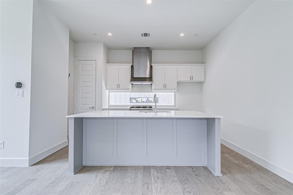 6028 Lewis Street, Unit 204 Dallas, TX 75206 - Photo 19 of 39 a kitchen with kitchen island sink stove and cabinets