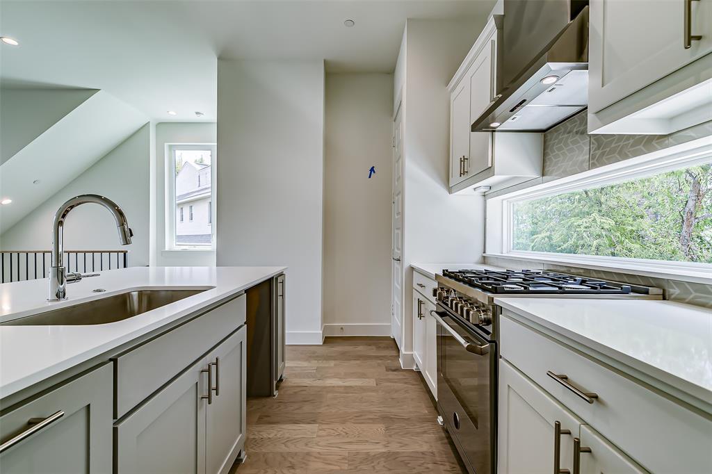 6028 Lewis Street, Unit 204 Dallas, TX 75206 - Photo 22 of 39 a kitchen with granite countertop a stove and a sink