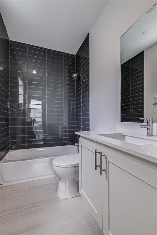 6028 Lewis Street, Unit 204 Dallas, TX 75206 - Photo 28 of 39 a bathroom with a sink toilet and shower