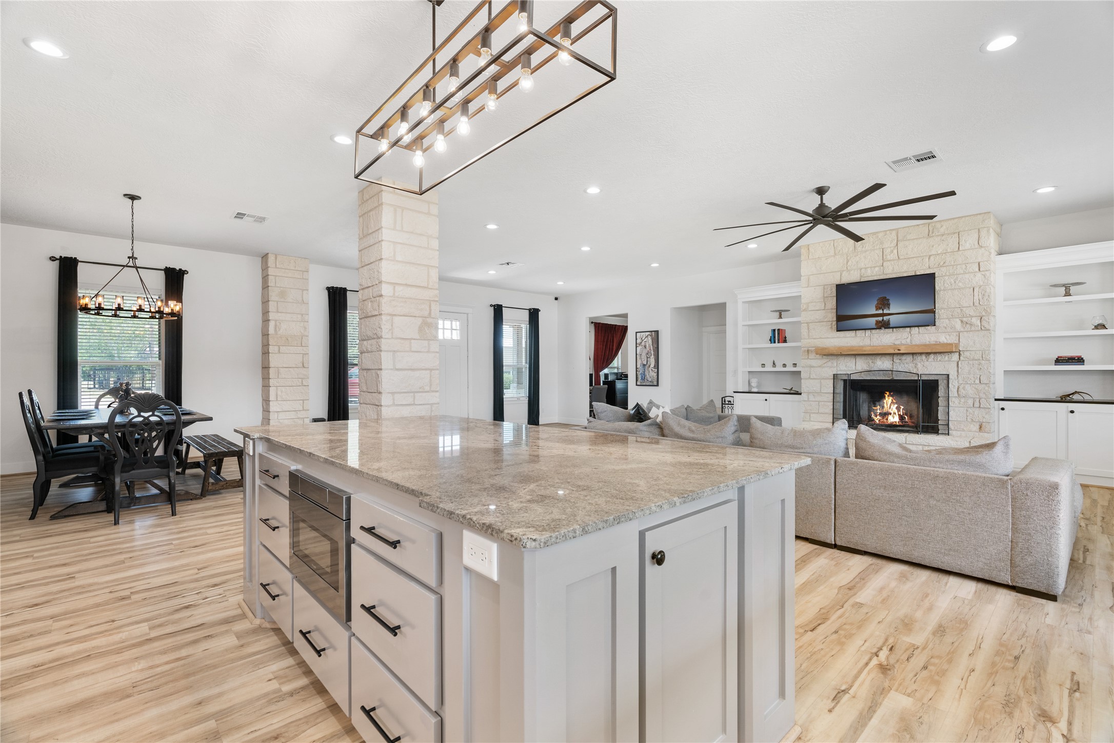 41111 Community Road Magnolia, TX 77354 - Photo 13 of 49 a kitchen with stainless steel appliances granite countertop a sink a stove and a wooden floors