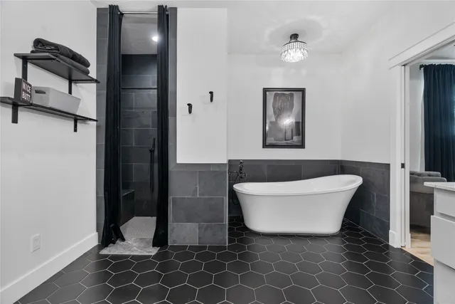 a bathroom with a bathtub and shower