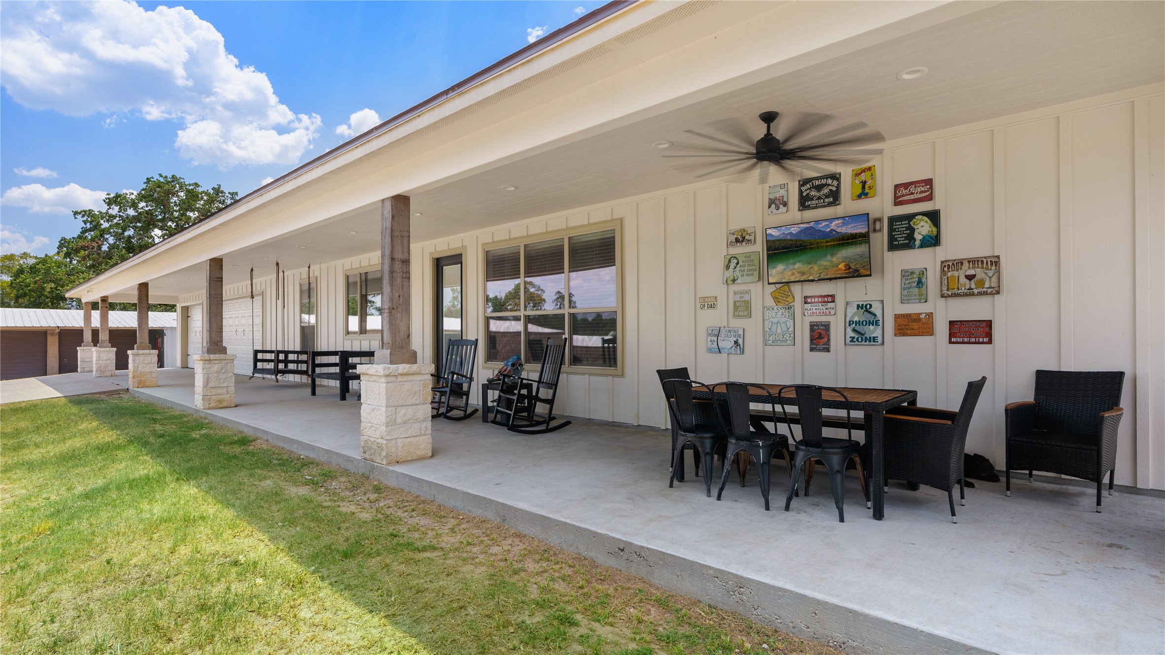 41111 Community Road Magnolia, TX 77354 - Photo 32 of 49 a view of a patio with dining table and chairs with plants and a barbeque