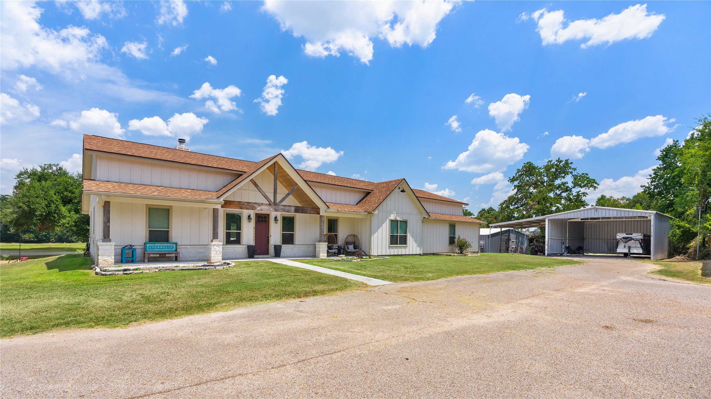41111 Community Road Magnolia, TX 77354 - Photo 4 of 49 a front view of a house with a garden and trees