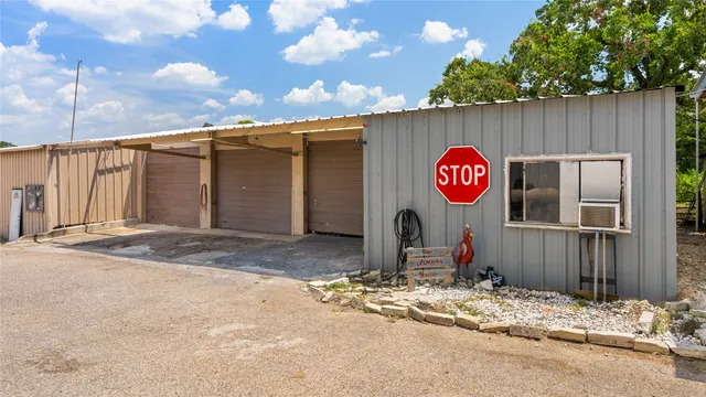 a view of a wooden house next to a road