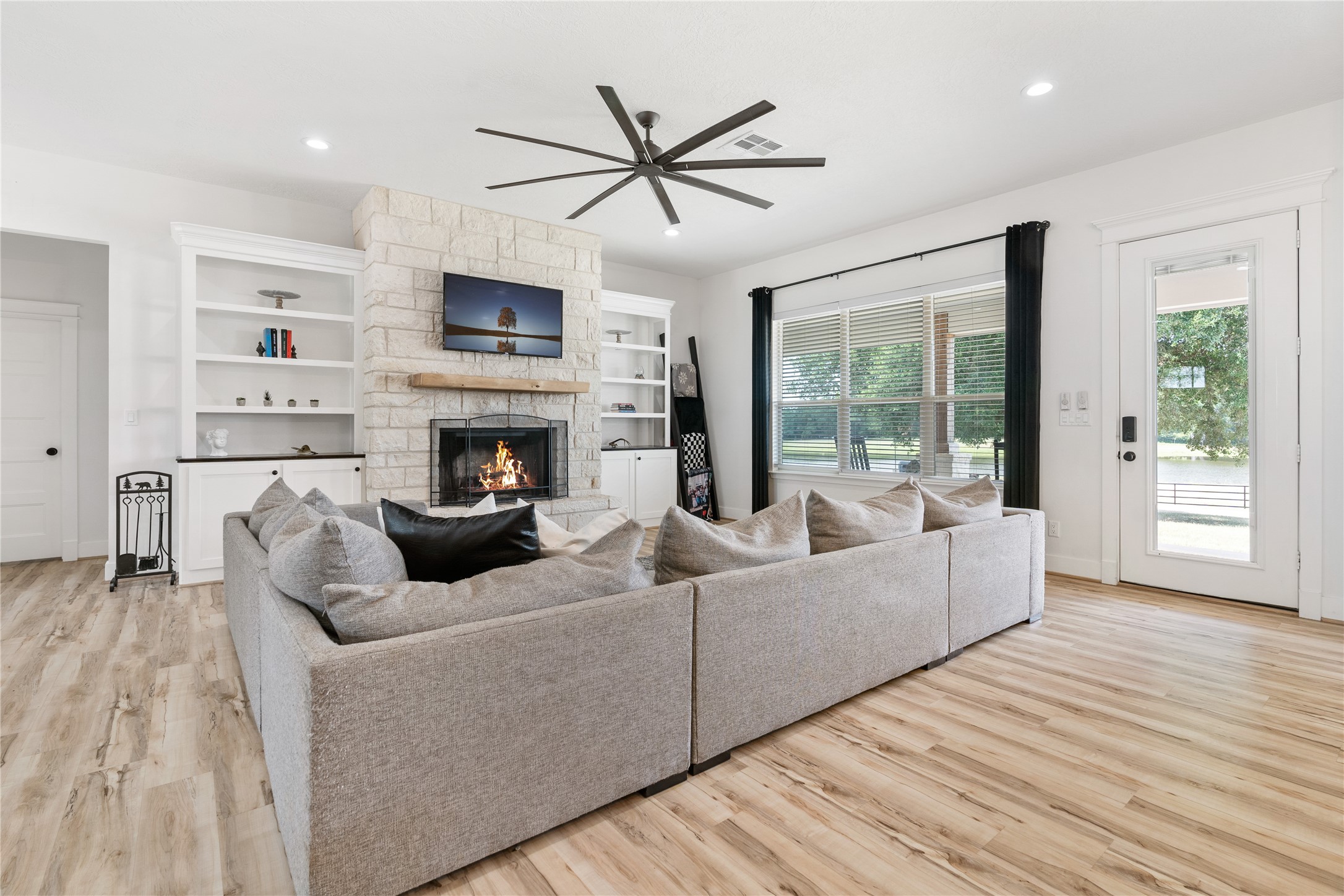 41111 Community Road Magnolia, TX 77354 - Photo 6 of 49 a living room with furniture fireplace and a large window