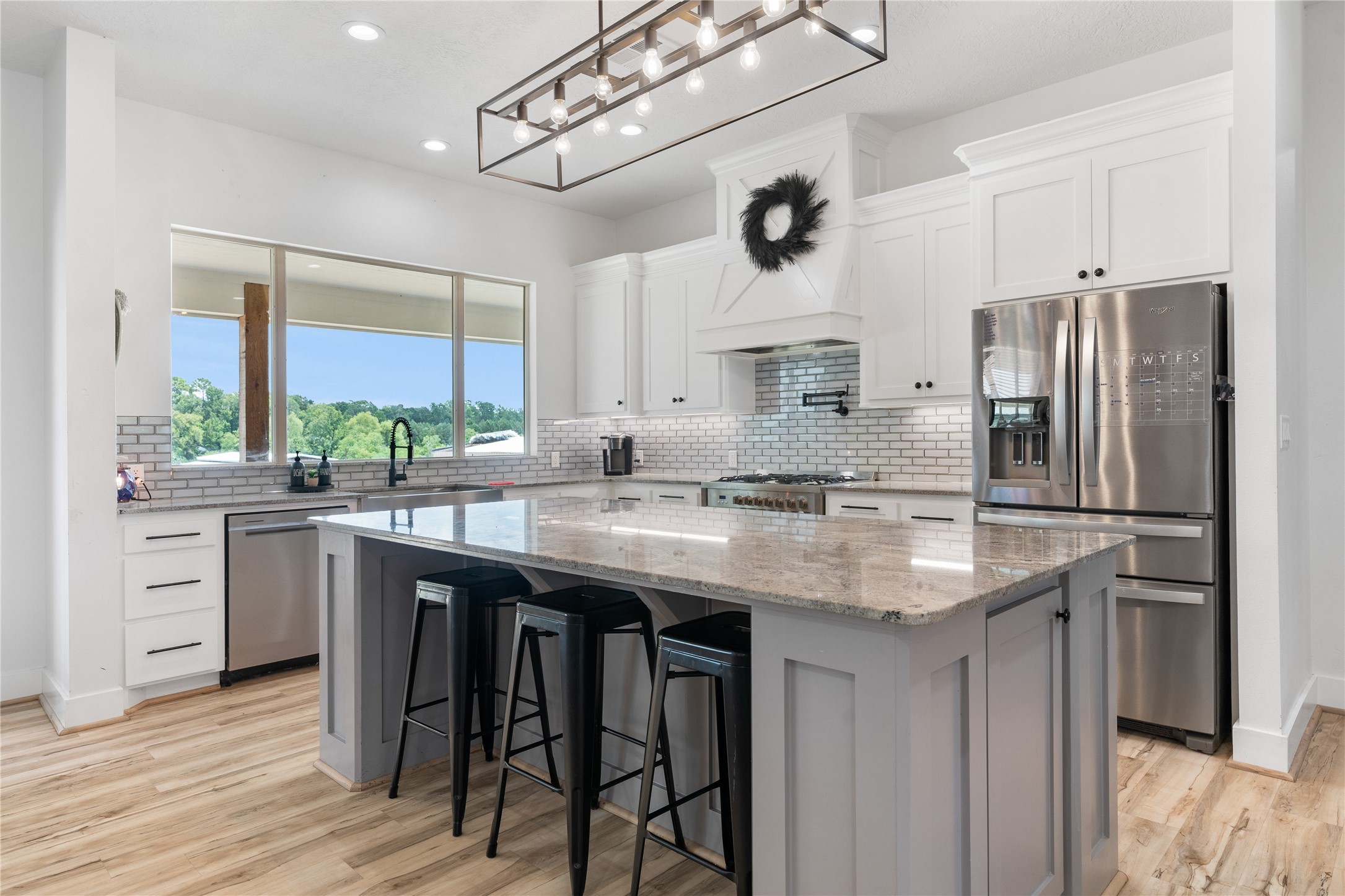 41111 Community Road Magnolia, TX 77354 - Photo 10 of 49 a kitchen with stainless steel appliances granite countertop a sink a stove and a refrigerator