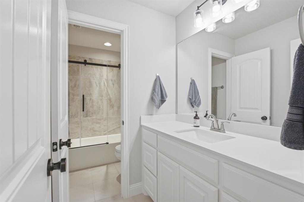313 Tate Lane Anna, TX 75409 - Photo 22 of 30 White vanity with integrated sink and chrome faucet