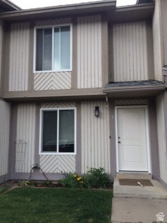 1269 North 400 East, Unit 3 Logan, UT 84341 - Photo 5 of 23 Vertical siding exterior with contrasting trim, featuring a prominent white entry door