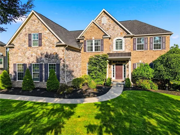 a front view of a house with a yard and potted plants
