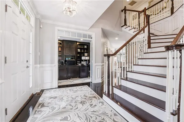 a view of a hallway with wooden floor and entryway