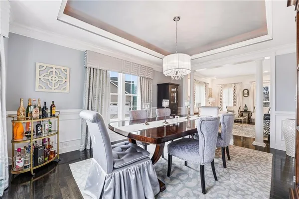 a view of a dining room with furniture and a chandelier