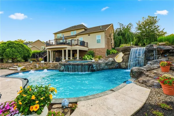 a view of a house with swimming pool and furniture