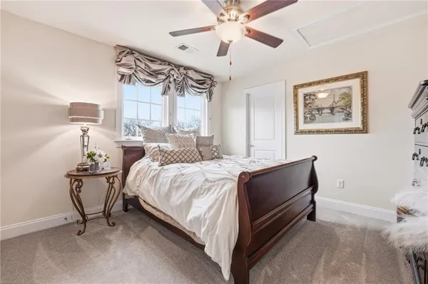 a spacious bedroom with a bed and a chandelier