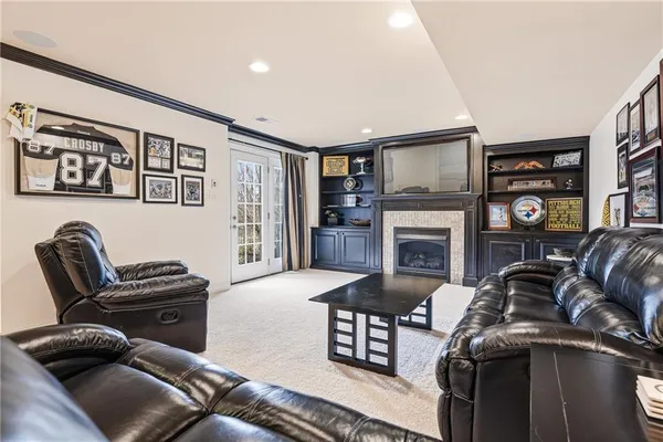a living room with furniture a fireplace and a flat screen tv