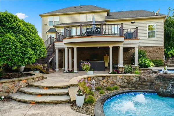 a front view of a house with garden and plants