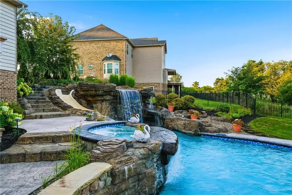 a view of a house with backyard and sitting area