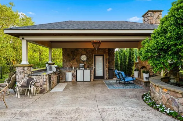 a kitchen with white cabinets and wooden floor