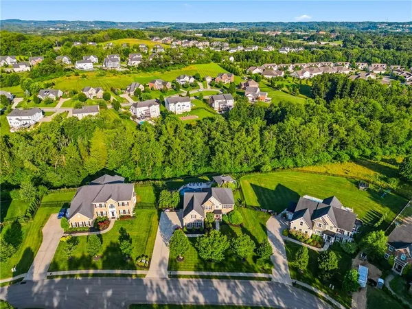 an aerial view of a house with a garden and swimming pool
