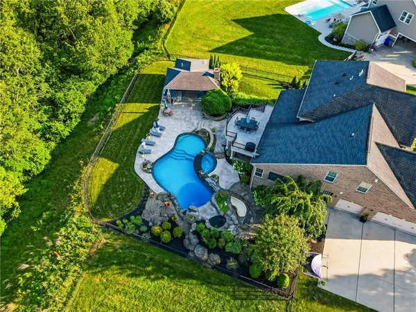 an aerial view of residential houses with outdoor space