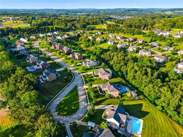 a front view of a house with a yard and potted plants