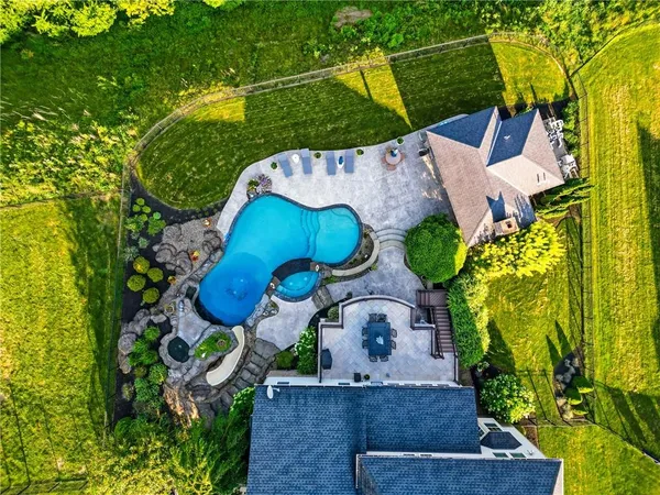 an aerial view of a house with a yard and lake view