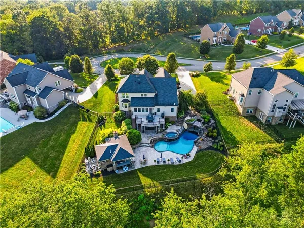 an aerial view of a house with a swimming pool yard and outdoor seating