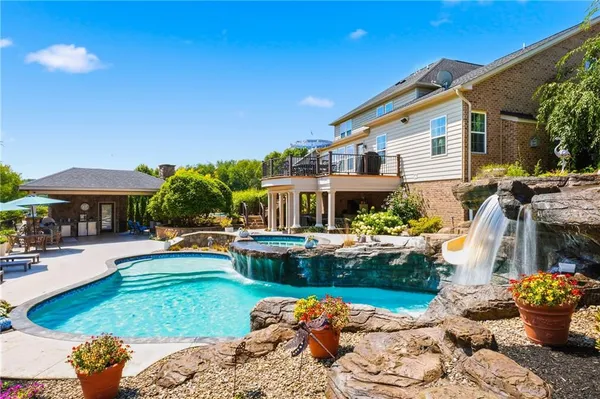 a front view of house with outdoor space and swimming pool
