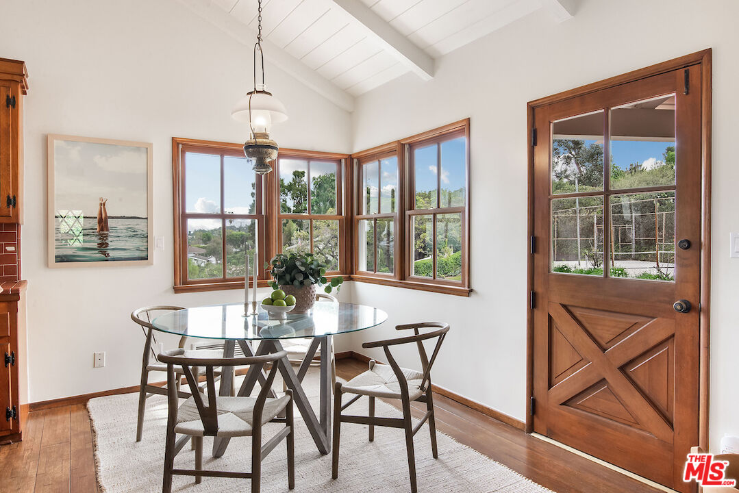 27280 Eastvale Road Palos Verdes Peninsula, CA 90274 - Photo 11 of 34 a view of a dining room with furniture large windows and wooden floor