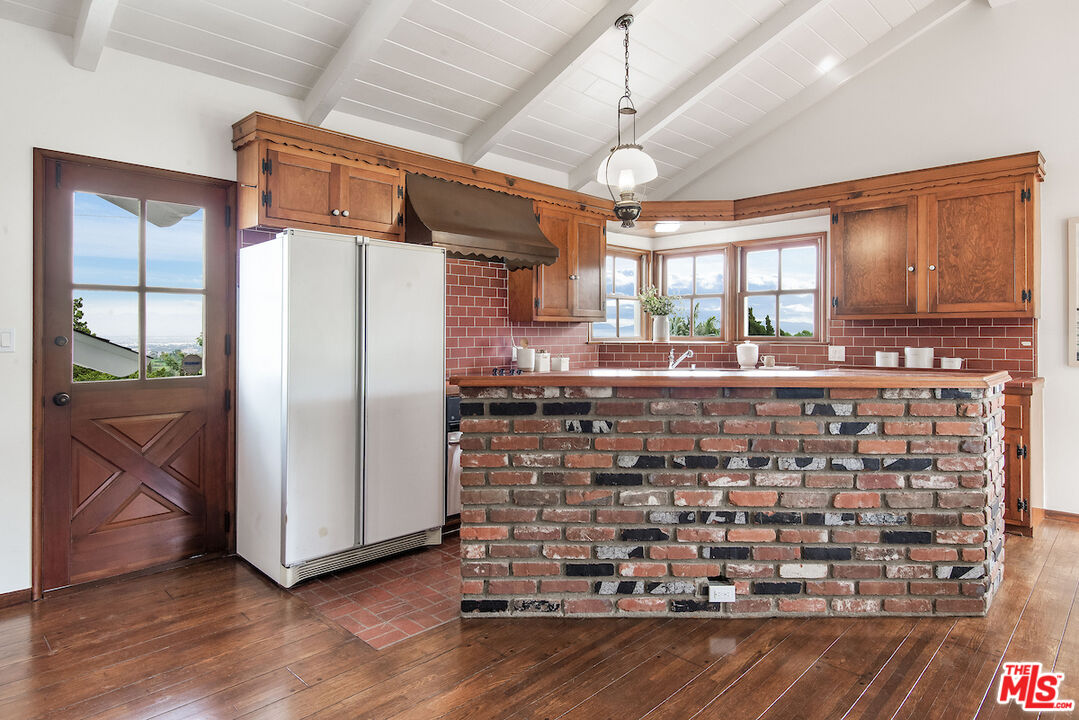 27280 Eastvale Road Palos Verdes Peninsula, CA 90274 - Photo 12 of 34 a kitchen with a refrigerator and wooden floor