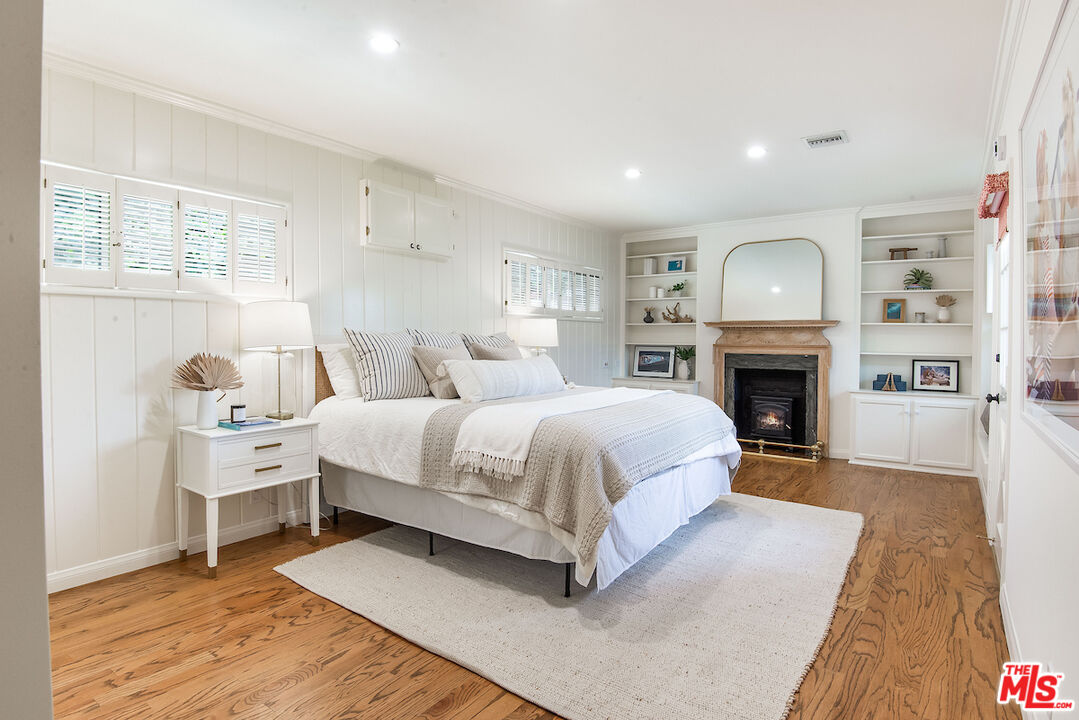 27280 Eastvale Road Palos Verdes Peninsula, CA 90274 - Photo 17 of 34 a spacious bedroom with a large bed and a fireplace