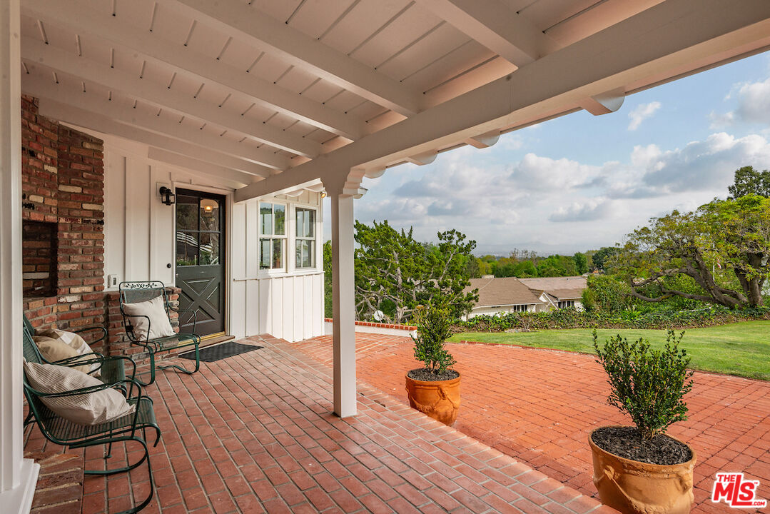 27280 Eastvale Road Palos Verdes Peninsula, CA 90274 - Photo 26 of 34 a view of a patio with table and chairs potted plants with wooden floor