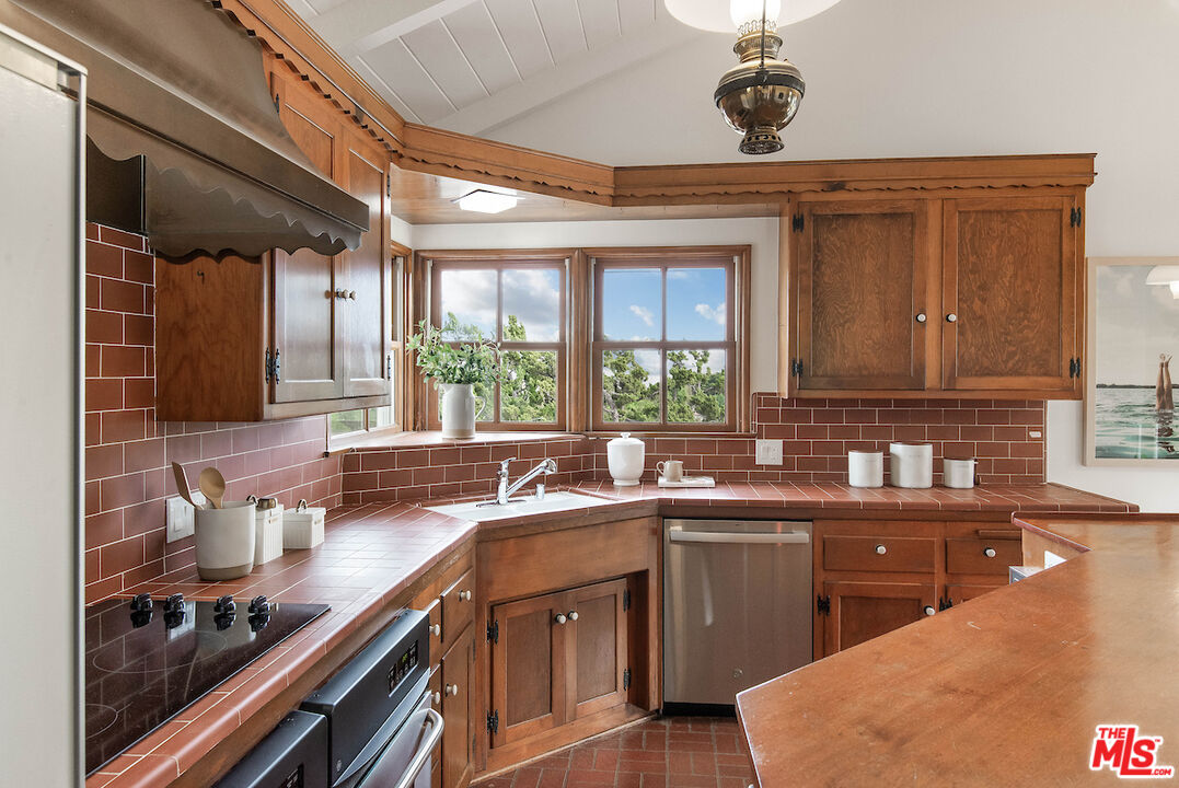 27280 Eastvale Road Palos Verdes Peninsula, CA 90274 - Photo 3 of 34 a kitchen with a sink stove and cabinets