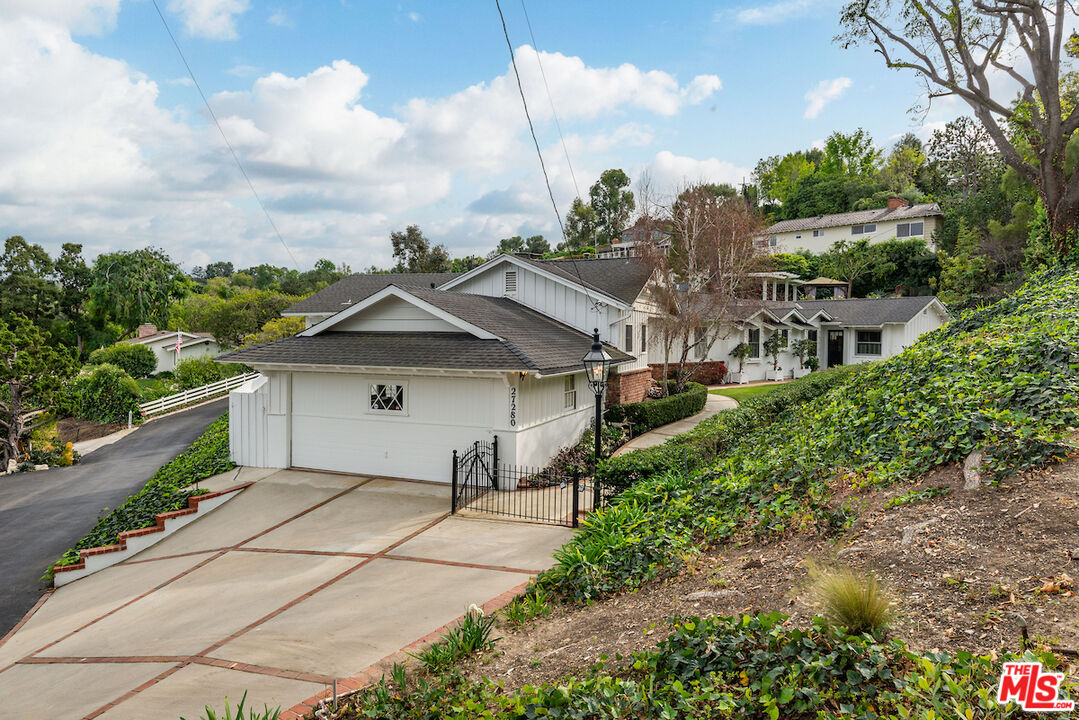27280 Eastvale Road Palos Verdes Peninsula, CA 90274 - Photo 34 of 34 a view of a house with a small yard and large tree