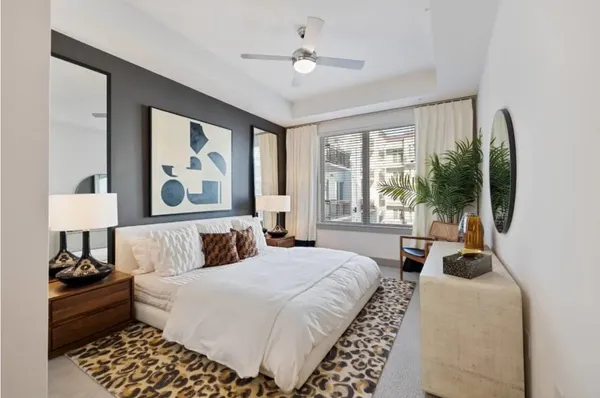 a bedroom with a large bed and a window